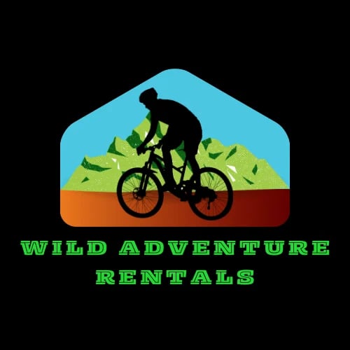 Wild Adventure Rentals logo featuring a silhouette of a cyclist riding a mountain bike on a trail with hills and green landscape